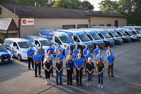 Team-outside-by-building-and-vans